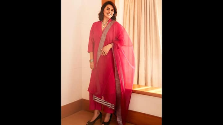 6. Minimalist Hot Pink Kurta Set: Neetu Kapoor wore a radiating and vibrant hot pink kurta set that proved simplicity can be the ultimate form of sophistication. Her three-piece ensemble featured a long, straight-cut kurta that she paired with palazzos. The sheer pink dupatta bordered with contemporary striped detailing added a subtle edge to the traditional silhouette. Styled with a statement pearl choker, silver bracelet, and black peep-toe heels, Neetu kept her accessories minimal yet striking. (Image Source: Instagram/@neetu54)