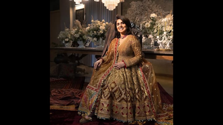 5. Regal Gold Gota Anarkali: Neetu Kapoor exuded a royal charm in her breathtaking burnished gold gota anarkali set. The intricately embroidered outfit featured luxurious textures, rich traditional motifs, and gota-patti detailing. The full-sleeved fit, complete with a voluminous flare was paired with a complementing dupatta that was adorned in heritage craftwork. The actress accessorised her regal look with statement jewellery that included a choker necklace and embellished juttis. Neetu Kapoor’s timeless style in this gota anarkali added a vintage and majestic touch. (Image Source: Instagram/@rimpleandharpreet)