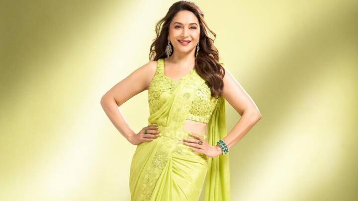 Neon Green Chiffon Bloom: Madhuri chose this light neon green chiffon saree with floral motifs and a matching sleeveless blouse. The light fabric and floral belt detail make it a breezy, stylish option for the festival. (Image Source: Instagram/ madhuridixitnene)