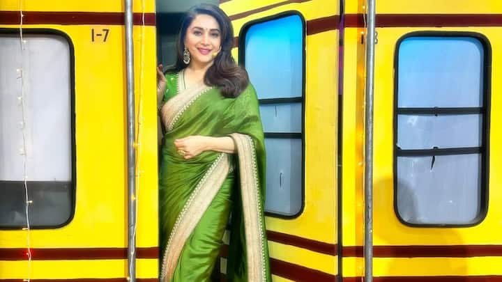Satin Parrot Green Grace: The actress chose festive simplicity in this parrot green satin saree with a light golden border. Combined with a matching blouse and traditional jhumkas, the look is ideal for stylish Teej celebrations. (Image Source: Instagram/ madhuridixitnene)