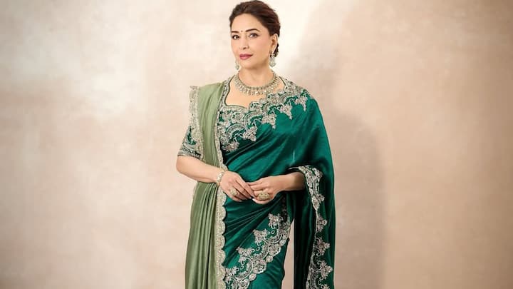 Emerald Silk Elegance: Madhuri Dixit shone in this emerald green silk saree with fine silver zardozi works on the palla and hemline. She wore it with a half-sleeve blouse with jaal embroidery all over, true to fit for Hariyali Teej celebrations. (Image Source: Instagram/ madhuridixitnene)