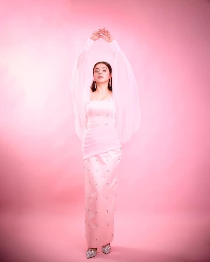 The aesthetic is unmistakably hyper-feminine yet powerful—blending old-school charm with millennial minimalism.