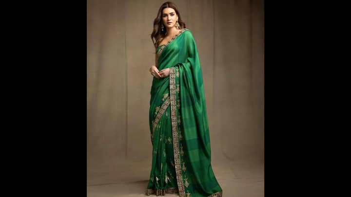 4. Classic Green Silk Saree: Kriti Sanon’s emerald green saree, wrapped in tradition and modern poise, featured rich green hue with subtle checks and delicate golden motifs. The zari-embroidered border with traditional patterns added depth, making it ideal for the nature-inspired festival. Kriti paired the saree with a sleeveless blouse and classic temple-style jhumkas. Whether you’re heading for a Teej puja or a festive lunch, this saree is perfect for creating an unforgettable vibe. (Image Source: Pinterest/kmpaulindia)