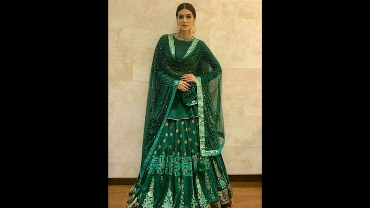 5. Regal Emerald Lehenga: Kriti Sanon served pure festive elegance in this emerald green lehega. Perfect for Hariyali Teej, the lehenga featured a rich flare embroidered with golden butis and floral zari borders. The shimmering net dupatta made the traditional outfit standout. It was delicately studded with sequins that added the right amount of sparkle to the Teej look. The actress kept the styling fuss-free with a sleek bun and statement bold jhumkas. The deep jewel tone aligned perfectly with the green theme of Teej, making it a timeless choice. (Image Source: Pinterest/sushbasu)