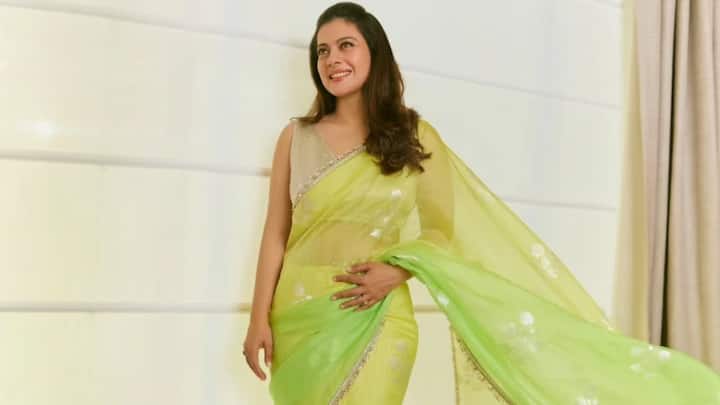 Kajol looked stunning in this green saree with a golden border and delicate embellishments, combined with a peach blouse. The dark makeup and tied hair gave her a festive look. (Image Source: Instagram/ kajol)