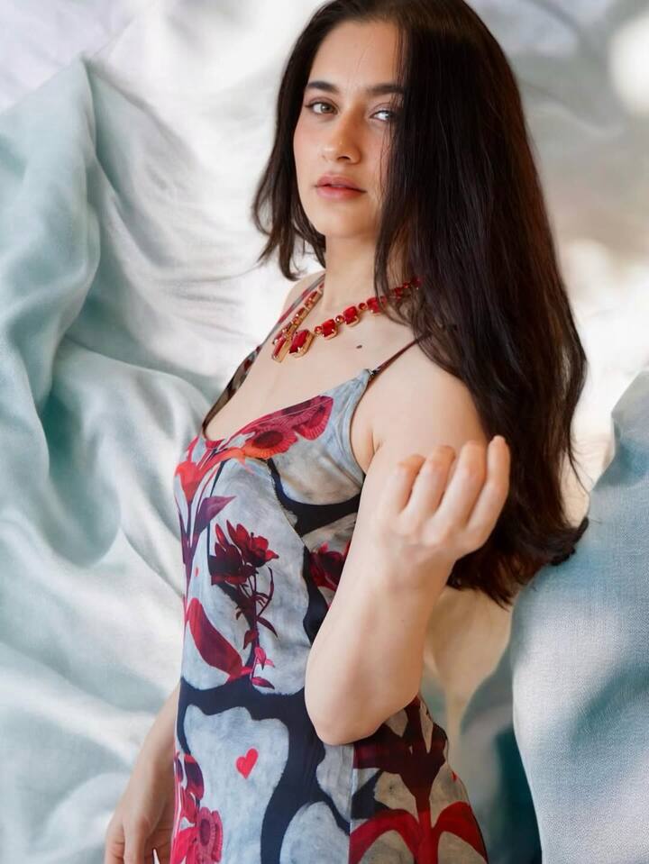 Sanjeeda posed against an airy, pastel-toned backdrop, giving major fashion-forward energy in a figure-hugging floral gown.