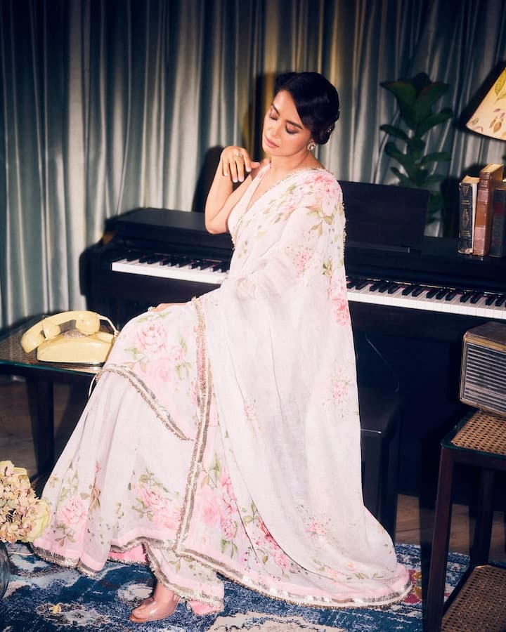 Surveen Chawla brought vintage charm and effortless grace to life in her latest appearance, donning a dreamy baby pink floral printed saree that radiated feminine elegance.
