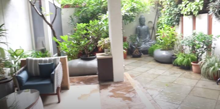 The kitchen is sleek, air-conditioned, and modern, and right next to it sits a peaceful temple corner that adds a spiritual vibe to the home.