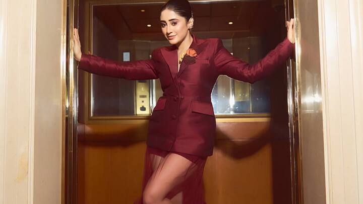 Power meets panache as Shivangi Joshi steps out in a sculpted burgundy creation, turning every corridor into a runway moment.
