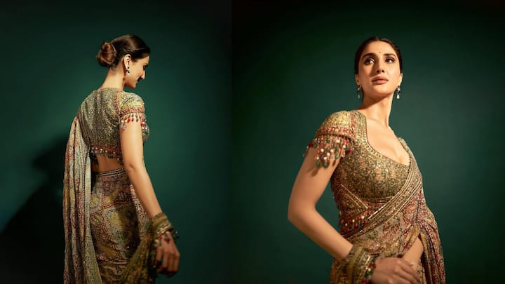7. Vaani Kapoor: Don’t shy away from experimenting with sleeve embellishments and daring necklines. Wearing this blouse, Vaani Kapoor blended tradition with modern-day glam. Her deep plunging blouse was intricately embroidered and had playful tassel detailing on the sleeves. The neckline added boldness while the sleeves gave a fun vibe to her look. The way this blouse paired with the rich traditional prints is what made it stand out. It’s versatile enough to be styled with a heritage silk saree, a printed drape, or even a cocktail-ready shimmer saree. (Image Source: Instagram/@vaanikapoor)