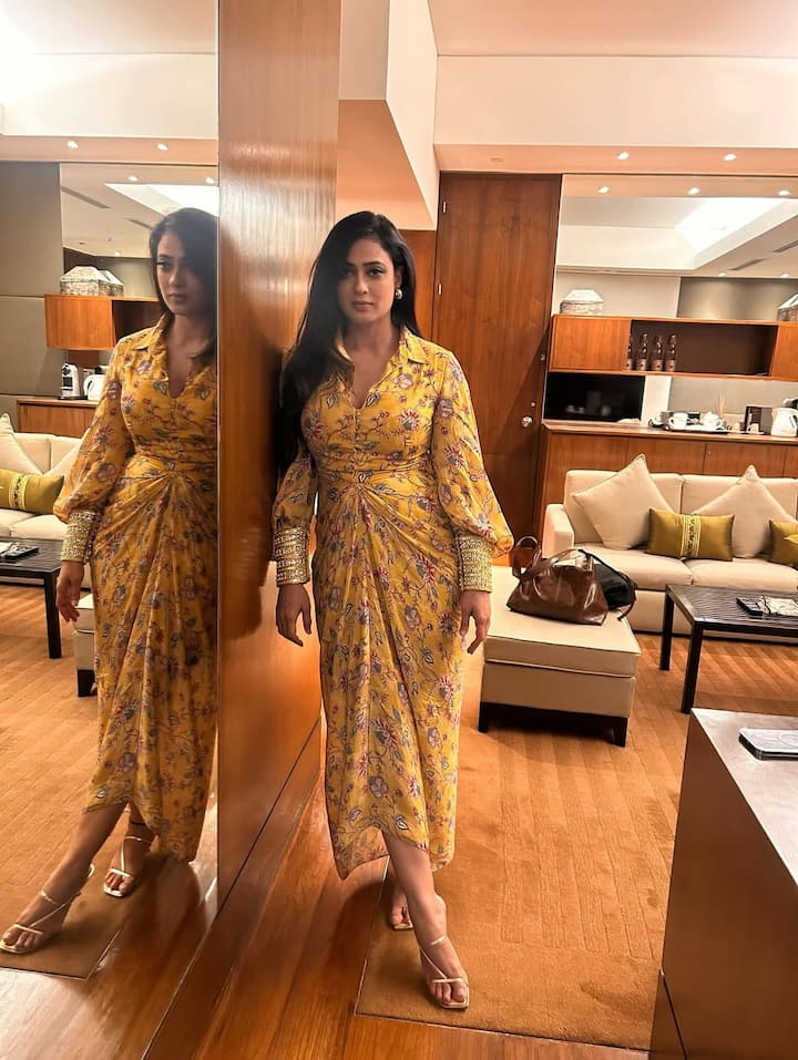Shweta wore a glamorous and elegant Yellow base floral drape style dress, which has full sleeves and glitter cuffs.