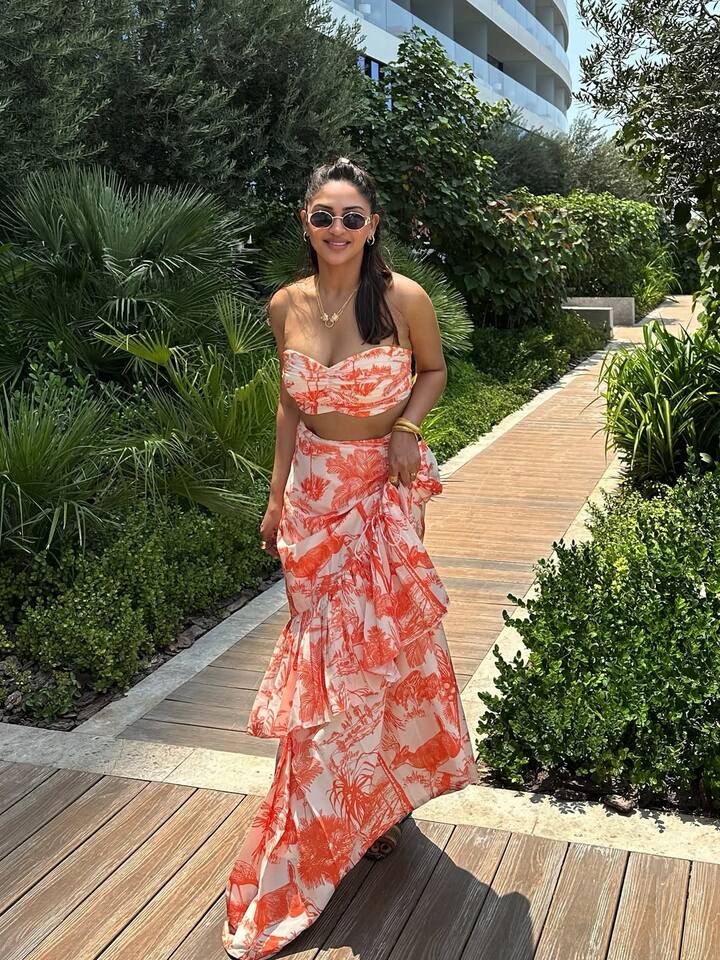 Krystle Dsouza steps out in a strapless bandeau and matching ruched skirt set, both covered in a striking coral-and-ivory palm print.