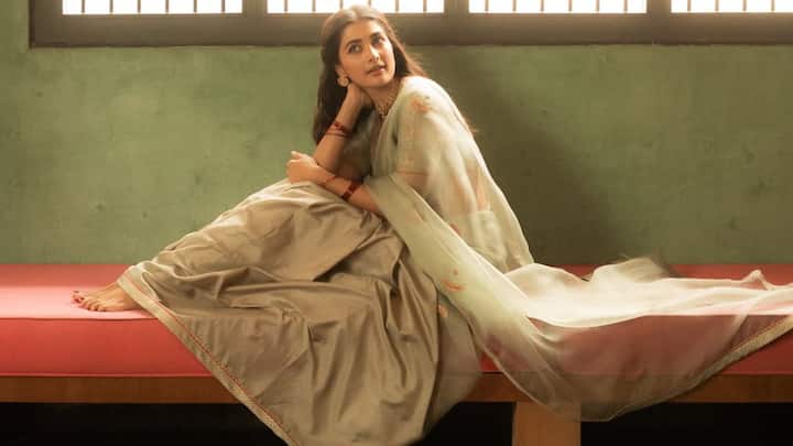 With all the retro vibes, Pooja sported this sage green saree with gold floral motifs and red-gold piping, while the floral blouse sleeves and red bangles gave a delicate traditional touch. (Image Source: Instagram/ hegdepooja)