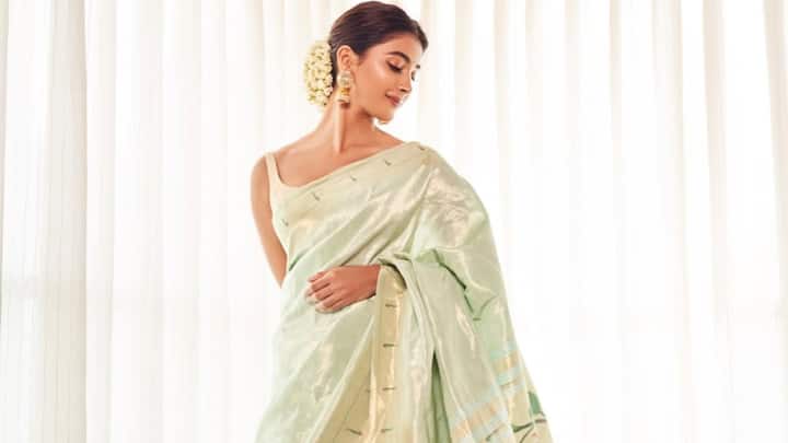 Playing it simple, Pooja chose this floral print saree and paired it with a gajra bun. The mojaris and minimal makeup made it an elegant choice for a festive daytime gathering. (Image Source: Instagram/ hegdepooja)