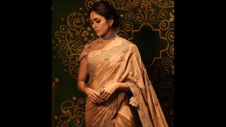 3. Gold Embroidered Saree: Mrunal Thakur’s golden saree look is the definition of regal sophistication. It’s a stunning choice for Raksha Bandhan 2025, if you want to keep your vibe classic. Draped in a rich saree with delicate tonal embroidery and scattered motifs, the actress brought back the grandeur of old-world charm. The muted gold tone served as the striking festive palette. Paired with minimal ring, earrings, and a statement choker necklace, the actress added a royal touch. This look is a must-try if you like elegance and heritage-inspired grace. (Image Source: Pinterest/pbsonawane2k18)
