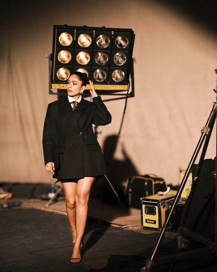 The actress paired it with a crisp white shirt and a tie, exuding a professional look through a sassy lens. She styled her hair in a neat bun and opted for contemporary accessories.