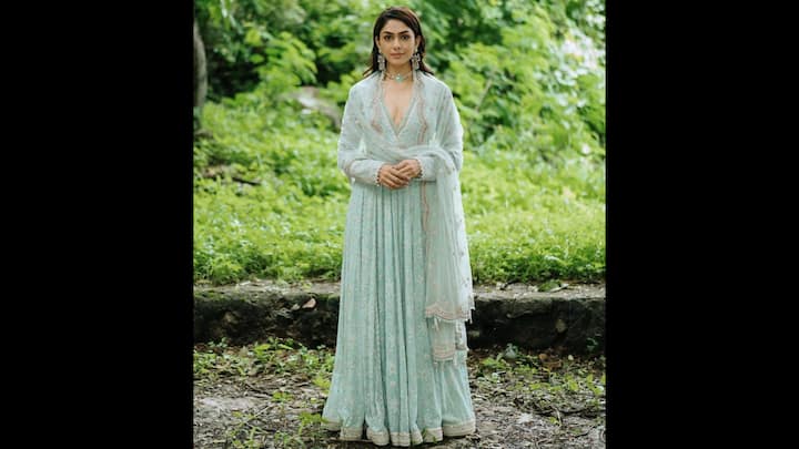 4. Powder Blue Anarkali Suit: For those who adore soft pastels, Mrunal Thakur’s powder blue Anarkali is a Raksha Bandhan 2025 showstopper. This flowy ensemble, delicately hand-embroidered with floral motifs, exuded ethereal charm. The dep V-neckline added a modern edge to the traditional silhouette, while the sheer dupatta with scalloped borders gave her a layer of feminine grace. Styled with a dainty choker and statement earrings the cool tone of her outfit gave a breezy vibe to the actress. (Image Source: Pinterest/poojakhambhala_)