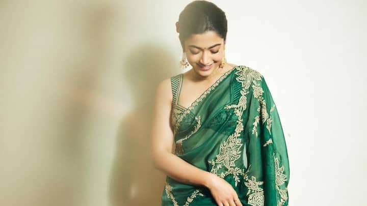 She dazzled in this dark green saree with golden floral embroidery. The heavy colour provides a celebratory, kingly finish, ideal for classic family occasions. (Image Source: Instagram/ rashmika_mandanna)
