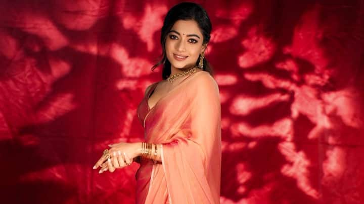 This coral chiffon saree with a cherry pink blouse is a fun yet sophisticated look. Its light drape and shine provide a flowy yet classy Raksha Bandhan choice. (Image Source: Instagram/ rashmika_mandanna)