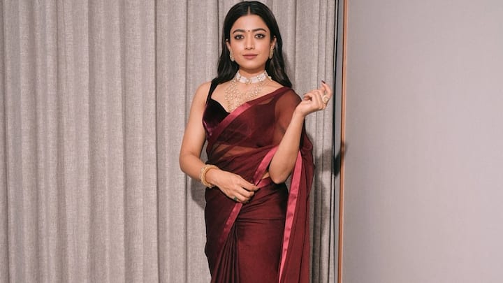 Her rich maroon sheer saree is eternally beautiful. This look is perfect if you are aiming for something festive and bold with a hint of traditional opulence. (Image Source: Instagram/ rashmika_mandanna)