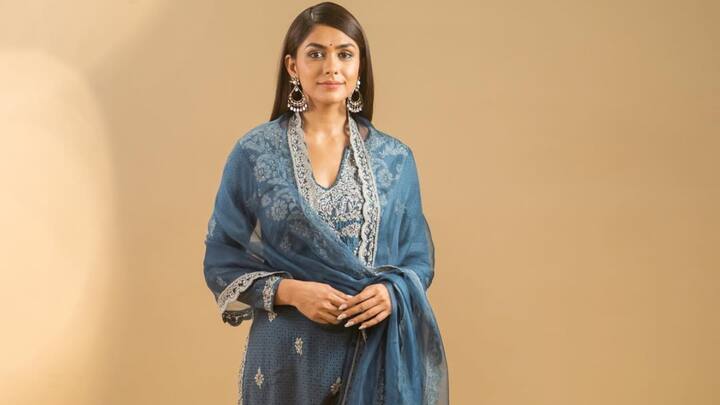 Mrunal Thakur exudes regal elegance in this indigo blue salwar kameez, which has floral embroidery with stone detailing and thick lacework. With a coordinating dupatta, this is a great choice for a bold and conventional style fan. (Image Source: Instagram/ mrunalthakur)