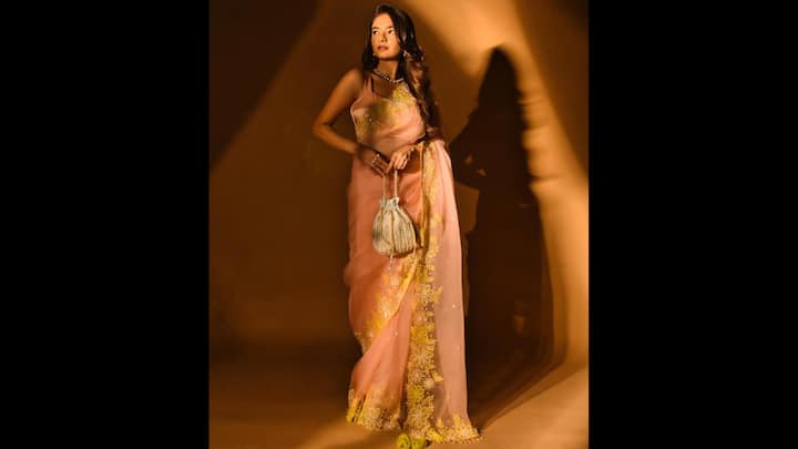 7. Peach Saree With Yellow Floral Embroidery: Anushka Sen’s peach organza saree with vibrant yellow floral embroidery is a showstopper for festive occasions like Raksha Bandhan 2025. The sheer fabric brought a youthful, breezy appeal while the contrasting yellow embroidery added a burst of vibrancy to the look. Paired with a delicate blouse and a chic potli bag, this saree blends tradition with a contemporary twist. (Image Source: Instagram/@anushkasen0408)