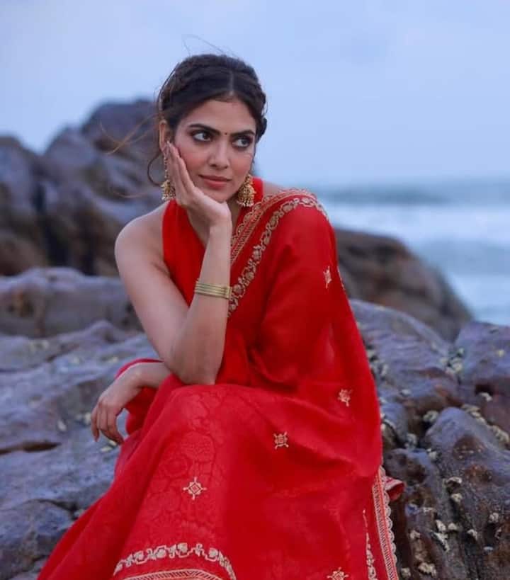Serving Regal Realness in Red: She owned the room in a vibrant red saree with floral motifs, paired with a halter-neck blouse featuring bold cutouts. Jhumkas and a single matching bangle completed this effortlessly bold yet elegant look.