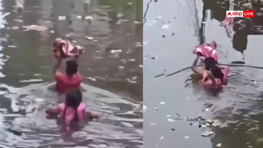 Video Flood wreaks havoc in UP Prayagraj father saves child like Vasudev watch the heart touching video Video: बाढ़ में डूबे पिता ने वसुदेव की तरह बच्चे को बचाया, तौलिये में लपेट ऊपर उठाया, देखें वीडियो