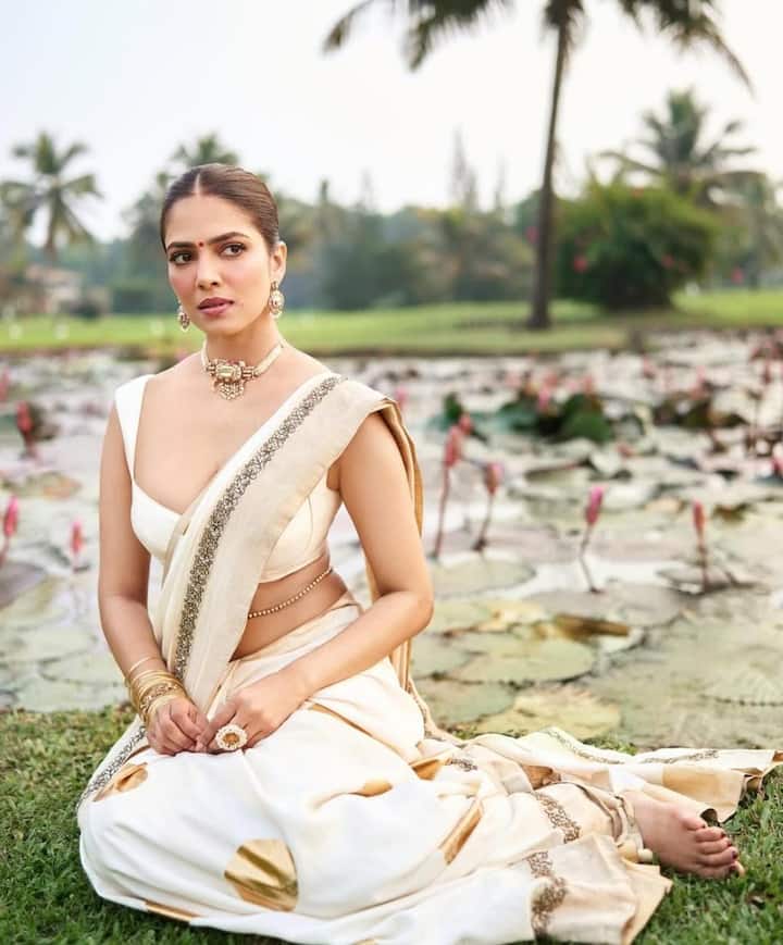 Angel in White and Gold: Malavika looked ethereal in a white and gold saree with circle motifs and a wide border, styled with a low-cut blouse, a regal Kundan choker, and a classic red bindi. Her neatly tied bun added to the divine aesthetic.