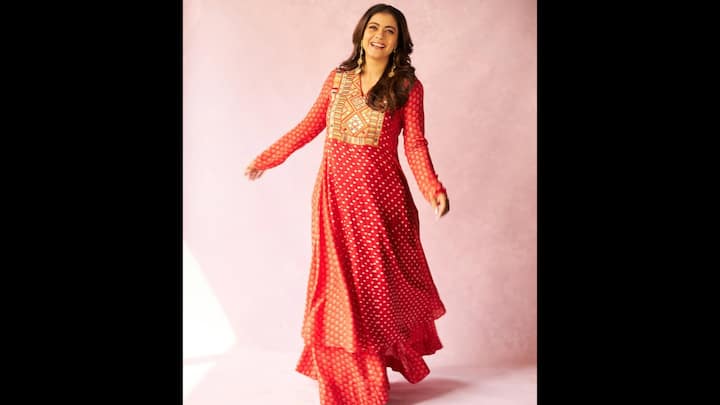7. Bold And Beautiful Red Look: The Bollywood diva wore a stunning red suit, perfect choice for the festive season. This outfit is a celebration of colour and traditional artistry, ideal for anyone wanting to embrace a classic yet stylish look. The flowing silhouette exuded grace and movement. The suit was adorned with delicate white polka dots, adding a playful and classic touch to the design. The embroidery work gave the outfit a rich, festive feel. Kajol paired the outfit with simple, elegant gold jhumkas that complemented the embroidery on the yoke without overpowering the look. (Image Source: Instagram/@kajol)
