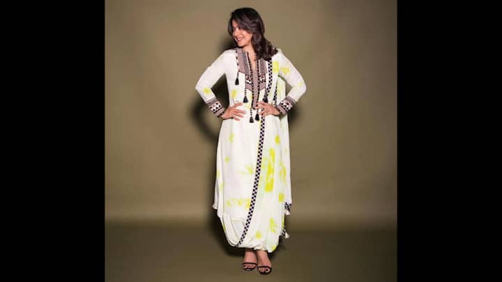 3. Yellow And White Dhoti-Style Set: Kajol wowed her fans with a stunning chic yet traditional ensemble that’s ideal for the festive season. This unique outfit featured a long, flowy kurta with intricate black embroidery and tassel detailing along the neckline and cuffs. She paired her kurta with a trendy dhoti-style bottom. The addition of a thin, embroidered black border on the dhoti and sleeves tied the whole look together. This modern silhouette is the perfect Raksha Bandhan 2025 look for anyone who is looking to blend tradition with contemporary style. (Image Source: Instagram/@kajol)
