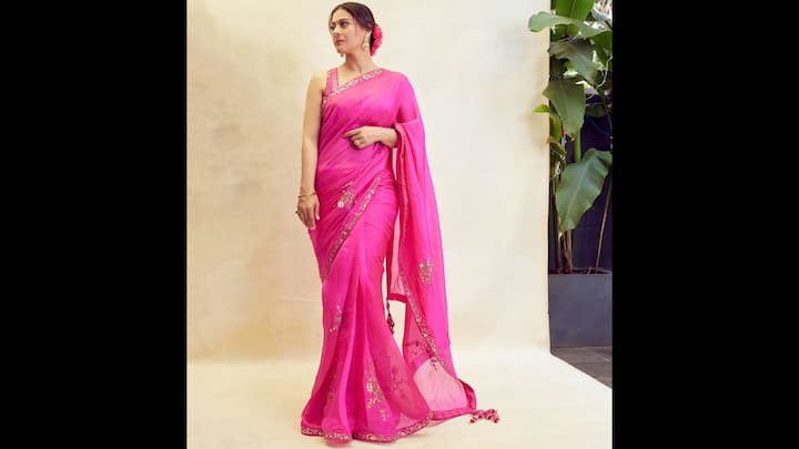 8. ⁠Hot Pink Saree: Kajol turned heads wearing a vibrant pink saree that defined festive elegance. This attire has a breathtaking hue, a colour that’s both traditional and trendy. The saree is adorned with delicate, shimmering embellishments and a subtle border that added a touch of sophistication. She paired the saree with a matching sleeveless blouse, keeping the focus on the vibrant colour and the exquisite drape. (Image Source: Instagram/@kajol)