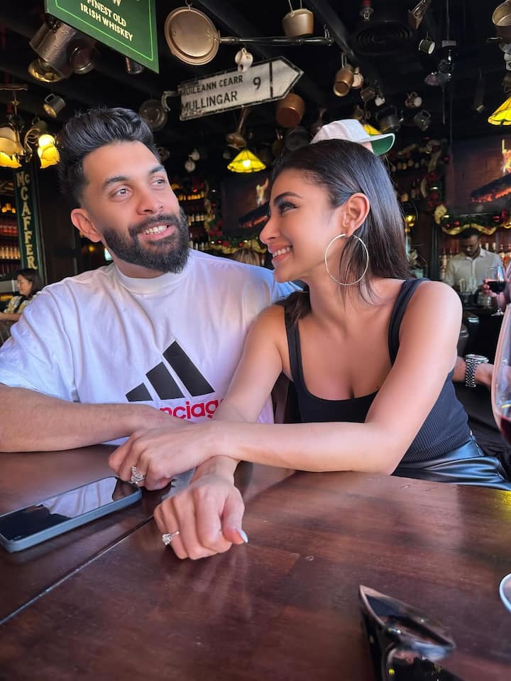 Mouni Roy & Suraj Nambiar’s Birthday Photo Dump Is Straight Out Of A Romance Film, See Pics Urban-setting shots feature Mouni in a white shirt, black pants, and a straw hat, while Suraj wears a monochrome casual outfit.