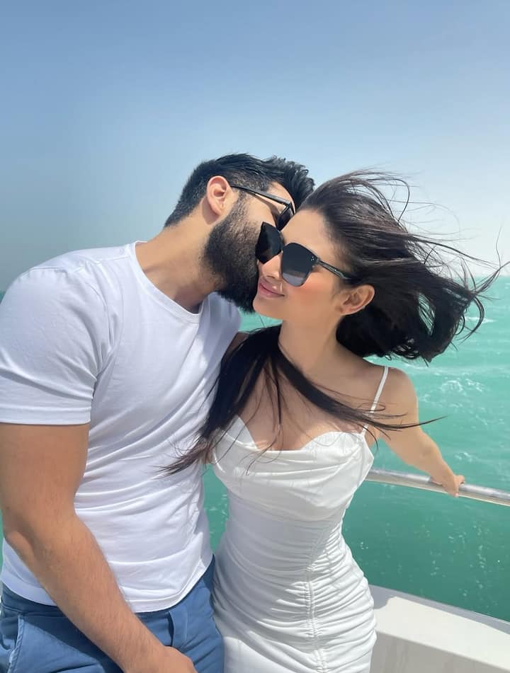 Mouni Roy & Suraj Nambiar’s Birthday Photo Dump Is Straight Out Of A Romance Film, See Pics In some pictures, the couple is seen on a boat with the ocean in the background, both in casual white outfits.