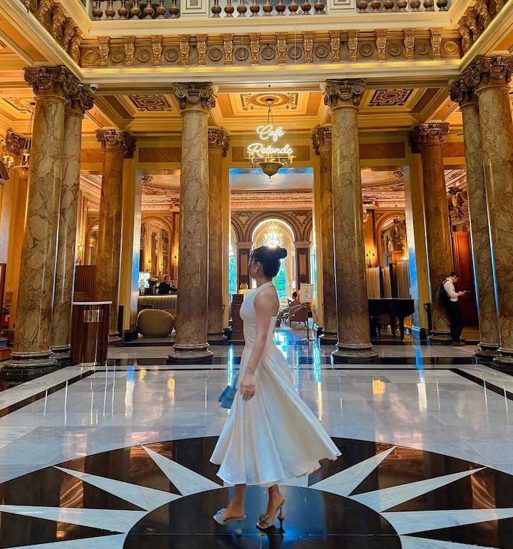 Makeup is kept natural yet glowing, featuring radiant skin, subtle blush, and nude lips.