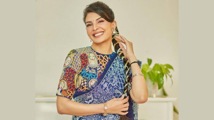 She stuns in this royal blue saree featuring contrasting white Resham embroidery and stone work, paired with a vibrant multi-coloured embroidered blouse for a striking festive vibe. (Image Source: Instagram/ jacquelienefernandez)