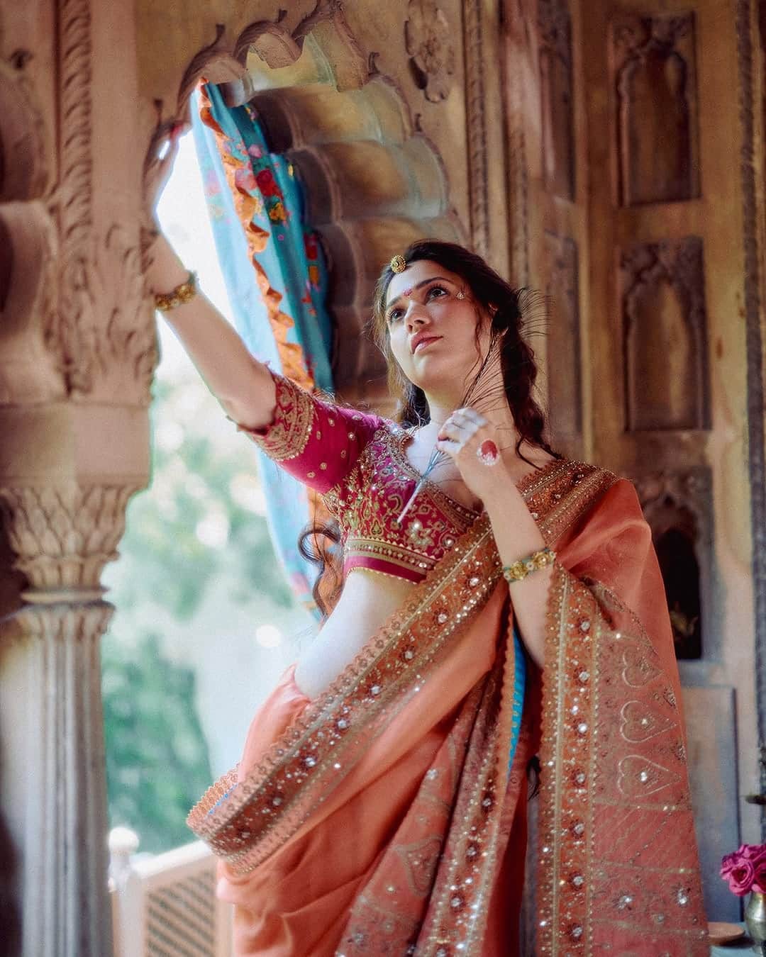 This Radha Rani look of Tamannaah Bhatia is quite tremendous. She has a heavy saree with a heavy embroidery blouse. He has completed his look with thick bracelet and open hair in his hands.