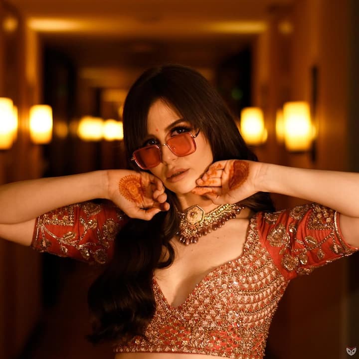 Regal Red Perfection- This is an example of bridal aligns, with a magnificent coral red lehenga, fine golden embroidery. The coordination of heavy embroidered choli and siege skirt offers the best balance of traditionalism and glamor. Georgia's statement jewelery and impeccable style make this look very attractive for any grand ceremony.