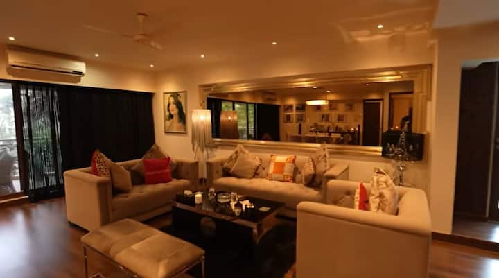 Amisha has kept the white shed couch in the living area. There is a brown table in the midst of which.