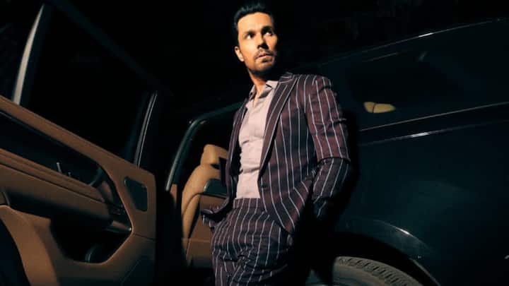 Pinstripe Power: Spotted in a bold Blue pinstripe suit, styled with a muted shirt and sleek loafers, he brings back vintage power dressing with a contemporary twist. Standing against his luxury car, the look radiates authority and charisma. (Image Source: Special Arrangement)