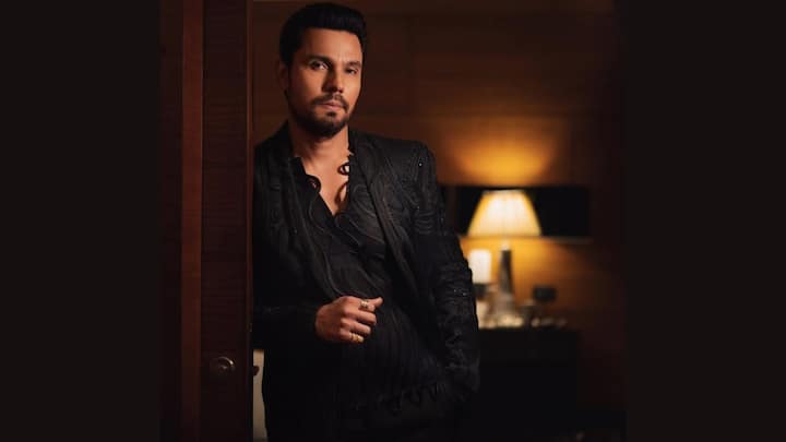 Textured All-Black Glam: Randeep rocks an intricately textured black suit layered over a wavy patterned shirt. The deep neckline, statement rings, and moody vibe make this an unforgettable red-carpet-ready moment, classic Randeep Hooda charm with a modern edge. (Image Source: Special Arrangement)