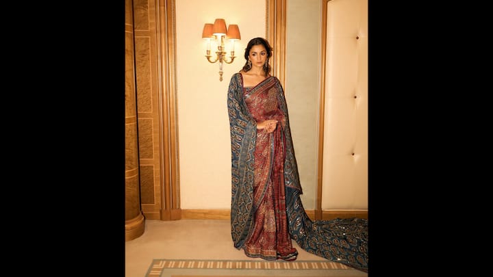 8. ⁠Alia Bhatt: Alia Bhatt exuded timeless grace in a handcrafted Ajrakh block print saree that celebrated India’s rich textile heritage. The deep maroon base, accentuated with intricate indigo and beige block motifs, gave the saree an earthy yet regal appeal. She paired her look with a matching blouse. This look beautifully fused heritage fashion with modern celebrity elegance. (Image Source: Instagram/@aliaabhatt)