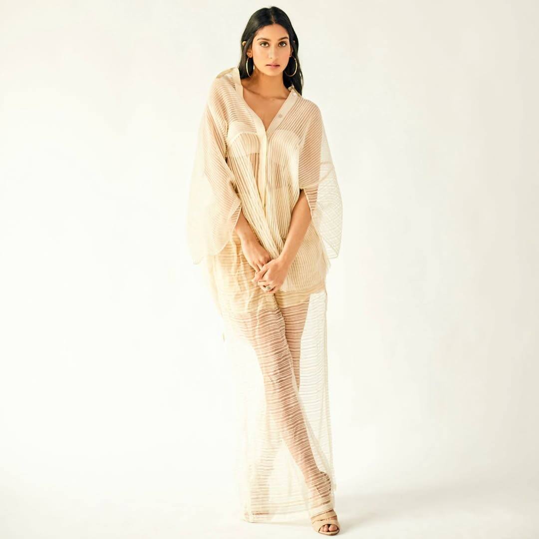 The actress wearing a transparent dress on the off white brolate is no less than a style icon. Along with the dress, he has also pairing matching earrings.