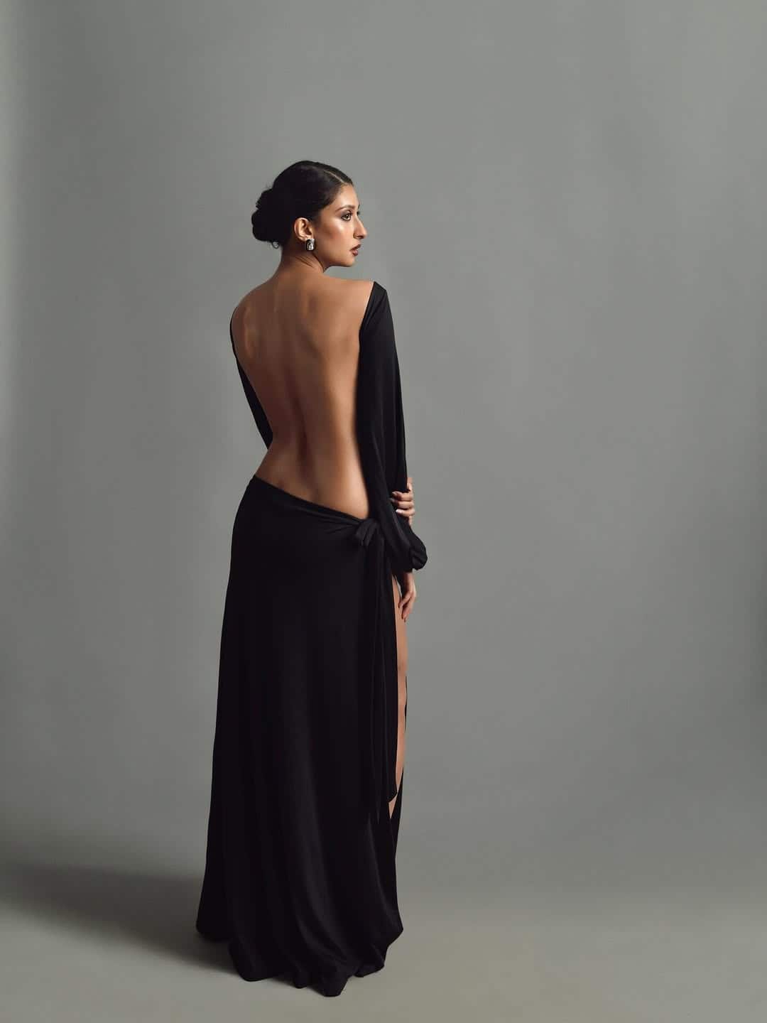 Paloma wearing this backless high slit dress looks quite glamorous. With smokey eyes and bun hairstyle, he has given a classy touch to his look.