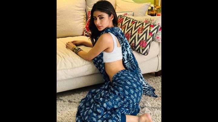 1. Mouni Roy: Mouni Roy brought effortless elegance to life in a classic indigo block-printed saree. The deep blue drape, adorned with delicate floral motifs and geometric borders, showcased the timeless artistry of Indian block printing. She paired the saree with a minimalist white bralette blouse, adding a contemporary edge to the traditional fabric. The look was rounded off with stacked metallic bangles, a dainty bindi, and anklets, striking the perfect balance between ethnic charm and boho chic. (Image Source: Instagram/@imouniroy)