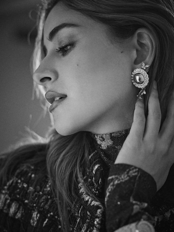 Her hair, styled in natural waves with a slightly tousled finish, adds to the raw and organic vibe of the portraits. There’s a quiet sophistication in the way she carries herself, letting her personality and grace shine through rather than relying on statement accessories or bold elements.
