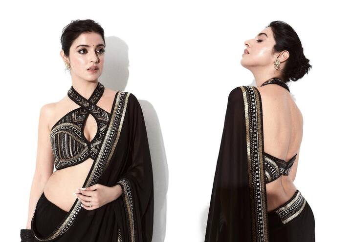 The actress is looking very glamorous in this saree. She has paired the saree for a matching backless halter neck blouse. She is looking very classy in this look.