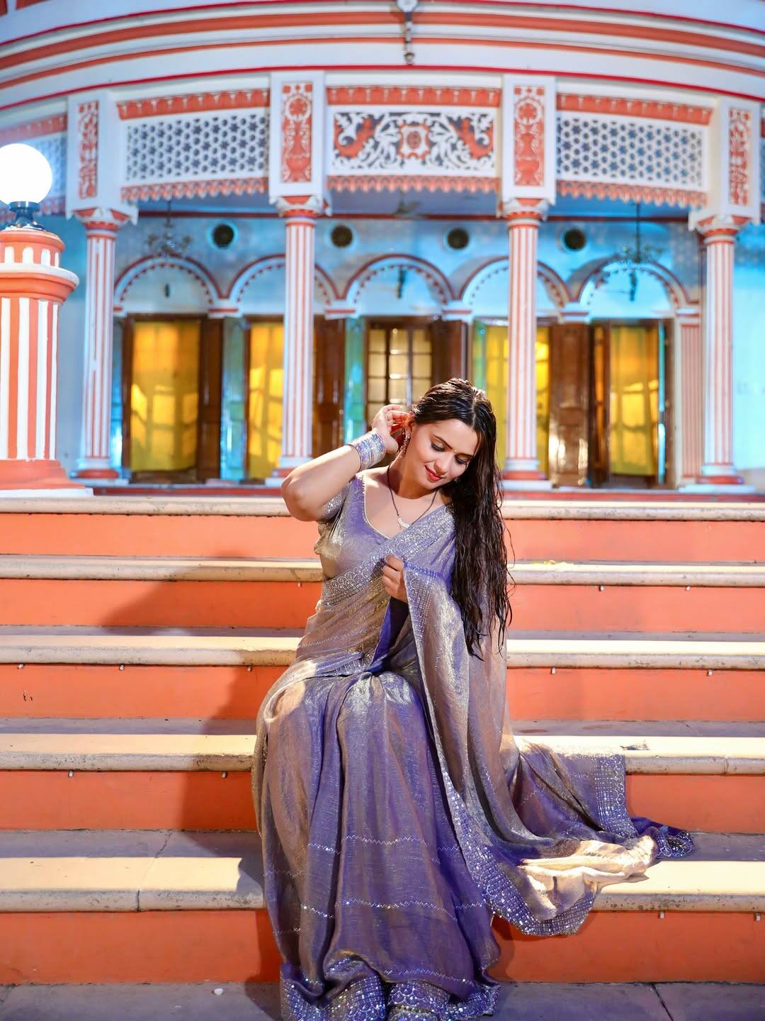 In this look, Neelam is wearing a shiny lavender colored saree on which silver caretaker has done. Wet open hair and bangles in hands are completing their look.
