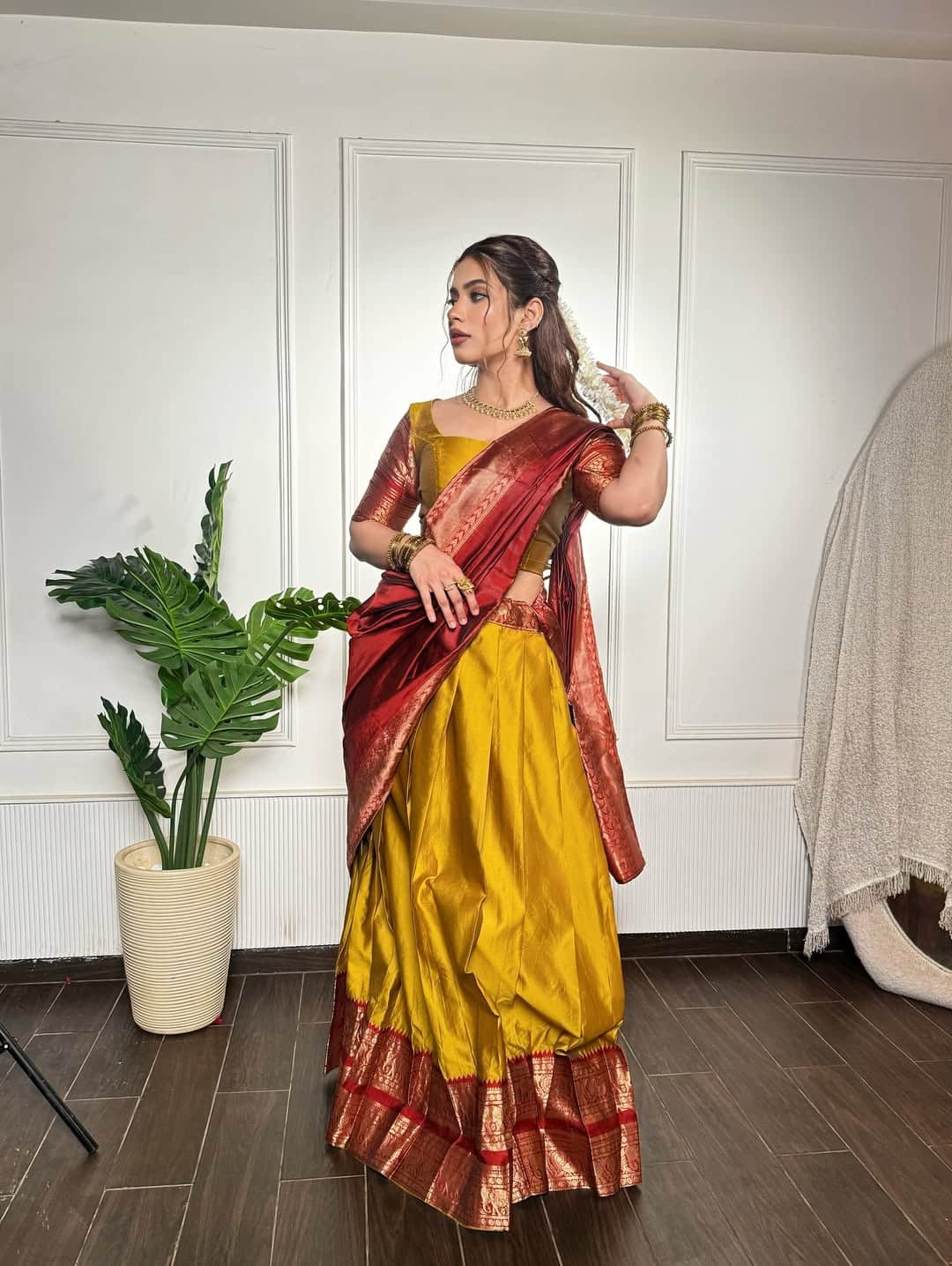 In this look, Nagma is wearing a yellow rich silk lehenga, which is decorated with maroon and golden border. With this, matching blouse and maroon silk scarf are making their entire look royal. Open hair, gold jewelery and bangles in their hands are completing their traditional style.
