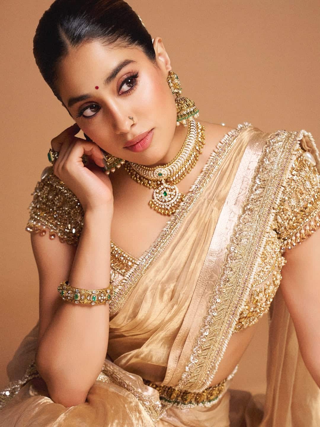 This look of Golden Drape, Heavy Blouse and Classic Jewelery, Jahnavi fits perfectly on a special occasion like Ganesh Chaturthi. Sleek hairstyle and bindi added glamorous touch to his desi charm.